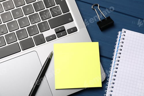 Preview: Laptop with sticky note, pen, paper clip and notebook on blue wooden table, closeup