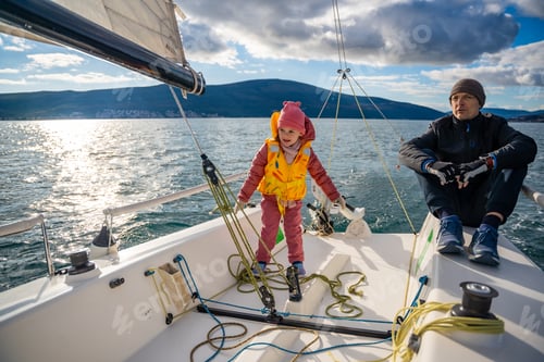 Preview: Father instructing daughter on sailing a yacht during training in the Kotor Bay, Montenegro
