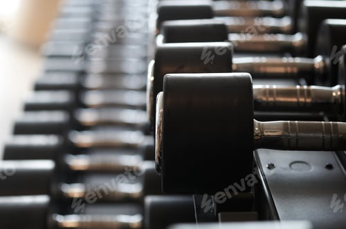 Preview: Closeup image of dumbells on a stand. Gym equipment