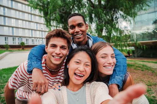 Preview: Group of young multiracial high school students taking a selfie portrait picture outside with a