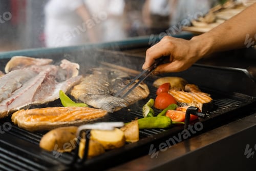 Preview: Grilled seafood mix: salmon, sea bass, vegetables, chili potatoes, tomato
