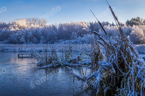 Preview: Sunrise on winter lake covered with snow