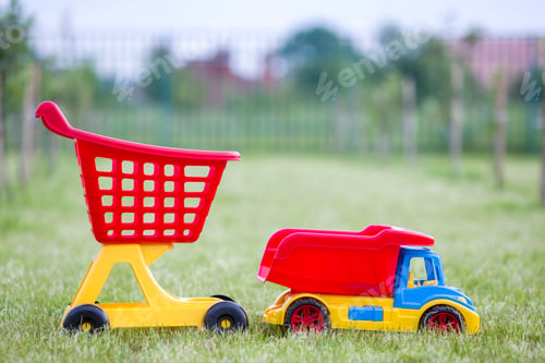 Preview: Bright plastic colorful toys for children outdoors on sunny summer day.