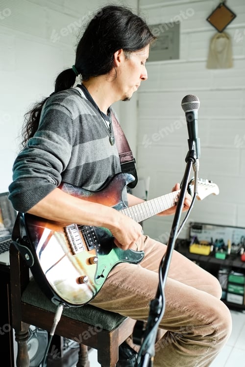 Preview: Guitarist concentrating on playing a musical instrument