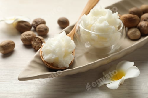Preview: Natural shea butter on white wooden table, closeup
