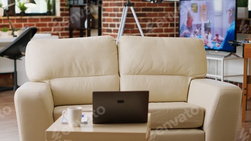 Preview: Interior of modern apartment with coffee table having laptop on it