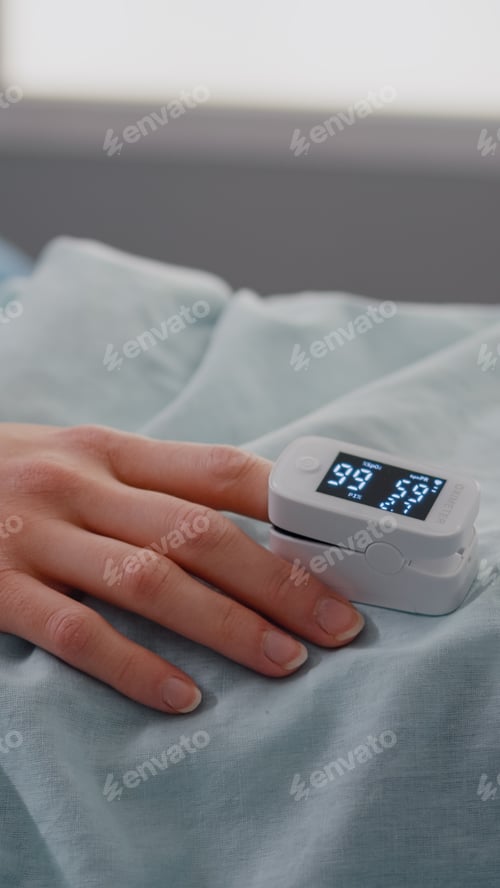 Preview: Close up of sick woman resting in bed in hospital ward