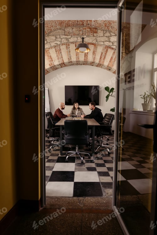 Preview: Group of professionals collaborating in a stylish and modern conference room
