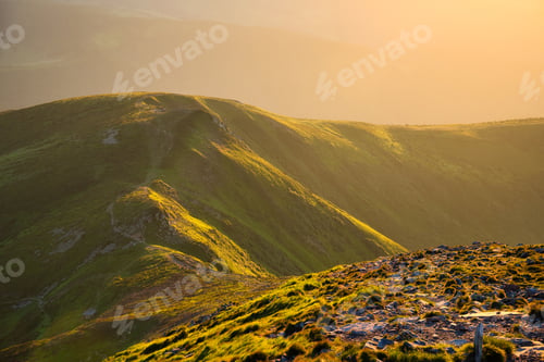 Preview: Mountains in fog at sunset in summer. Beautiful landscape