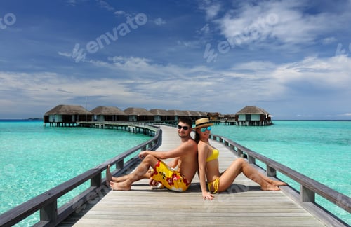 Preview: Couple On A Tropical Beach Jetty At Maldives