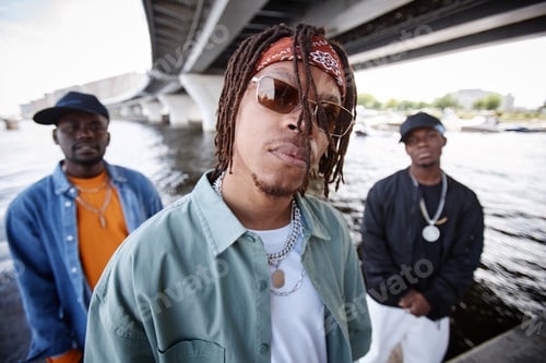 Aperçu: Young African American man with dreadlocks and headband looking at camera