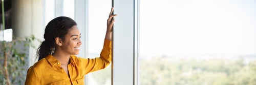 Preview: Successful african american businesswoman standing by window in coworking office