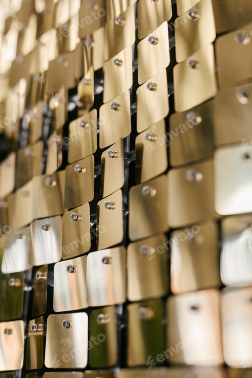Preview: Golden Metallic Tiles Reflecting Light in Modern Business Environment