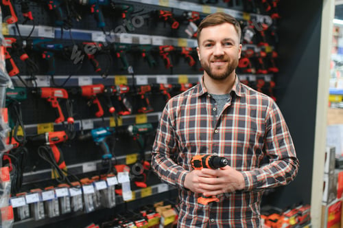 Preview: Portrait of happy mature man standing in hardware store