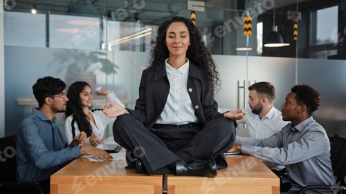 Preview: Calm businesswoman leader woman doing breathing yoga exercise taking break meditating sitting at