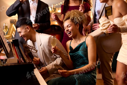 Preview: Group Of Friends Around Piano Celebrating At New Year Party Together