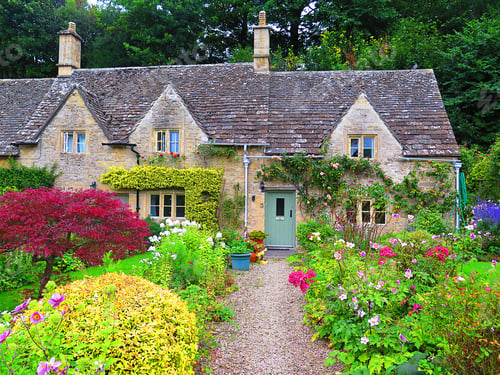 Preview: Garden and house in UK style. Front of English House. Scenic View of Colorful Flowerbeds and an Attr