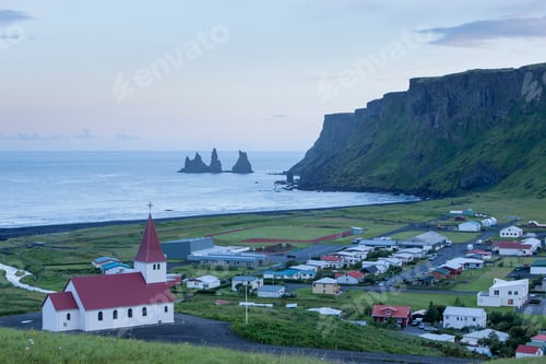 Preview: High angle view of Reynisdrangar basalt sea stacks and the village of Vik, Myrdalshreppur, Iceland