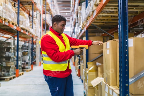 Preview: Warehouse worker scanning packages with barcode scanner