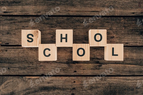 Preview: Top view of alphabet cubes with word school on wooden background
