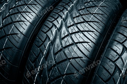 Preview: New tyres background. Car tyres close up