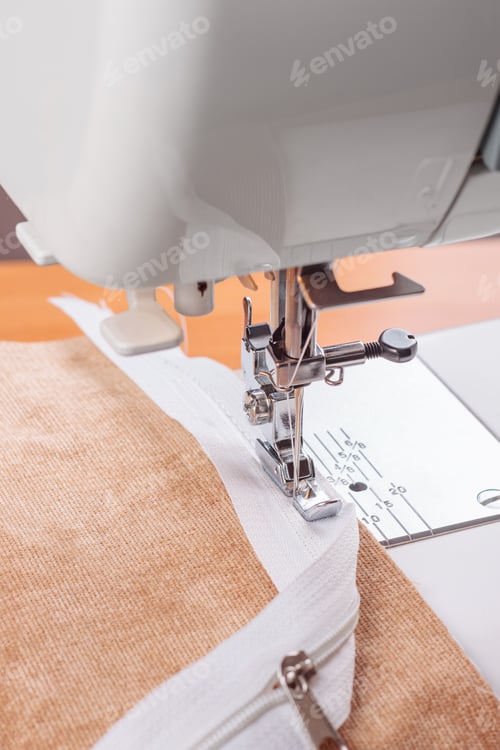 Preview: Modern Sewing Machine Special Presser Foot With Beige Fabric And Zipper, Closeup