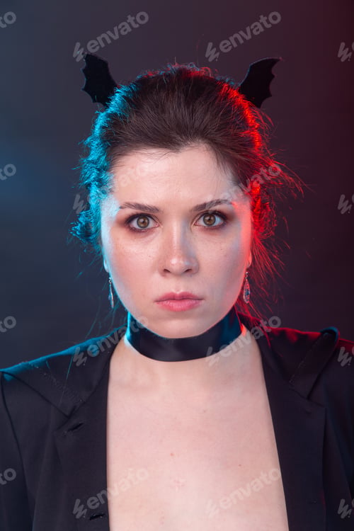 Preview: Halloween, holidays and carnival concept - vamp woman in jacket and with bat ears in gothic style