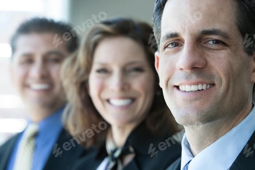 Preview: Three business people, head and shoulders, looking at camera portrait.