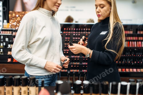 Seller helps woman with choice of eyeshadows