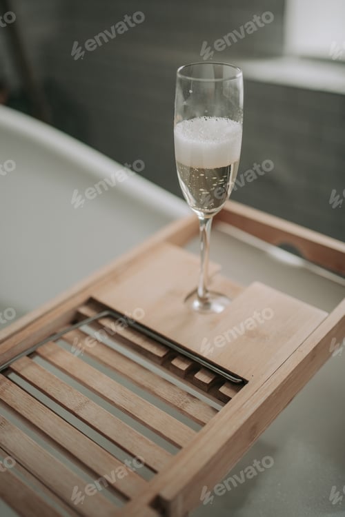 Preview: Luxury interior eco style modern bathroom with oval bathtub and champagne glass at natural lighting