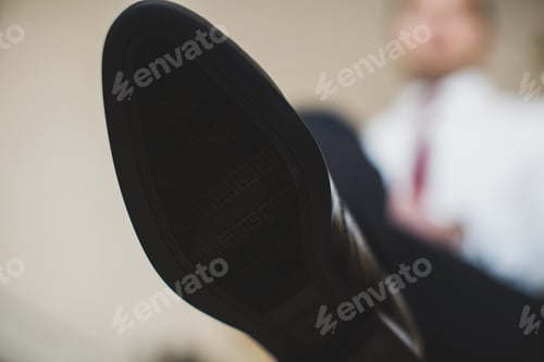 Preview: Man's hands tying shoelace of his new shoes. People, business, fashion and footwear concept