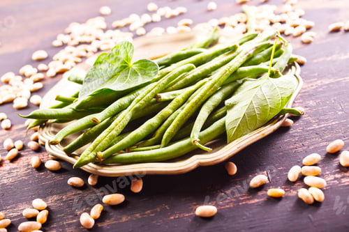 Preview: Heap of green pods of raw, not cooked, asparagus beans and white beans on a table