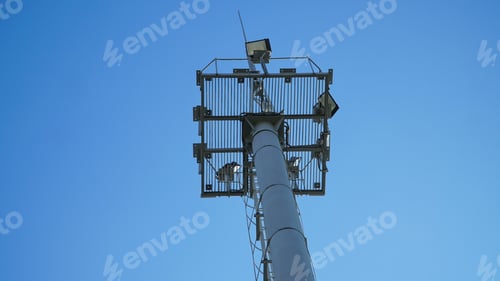 Preview: High lighting mast against the blue sky. View from below. Full height.