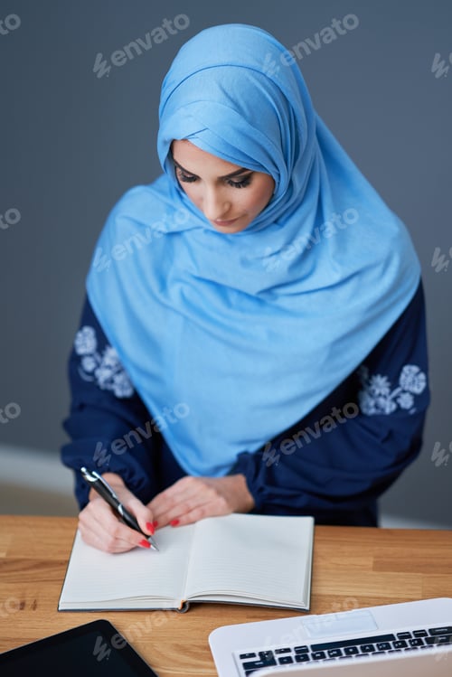 Preview: Muslim female student learning at home