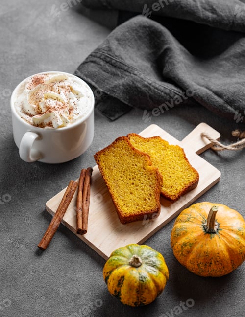 Preview: Slices of pumpkin sweet bread with cinnamon on a wooden board on a dark background