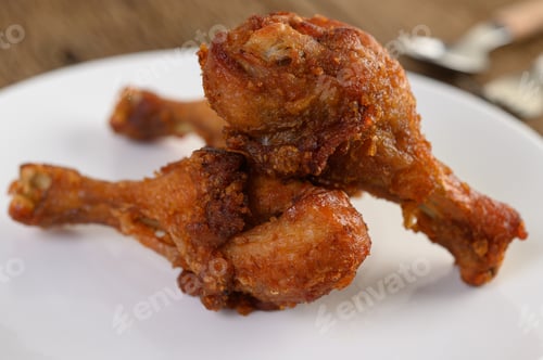 Preview: Fried chicken legs on a white plate