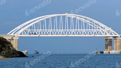 Preview: Breathtaking seascape with a white beautiful bridge with many moving cars above the water surface
