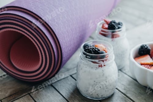 Preview: Berries and Yogurt Next to a Rolled Yoga Mat