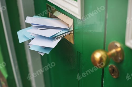 Preview: An entranceway filled with envelopes. Cropped shot of letters in a letter box.