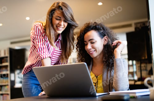 Preview: Group of college students studying in the school library