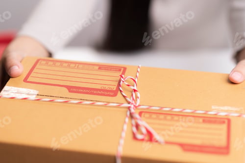 Preview: Girl's hands holding the package on the table
