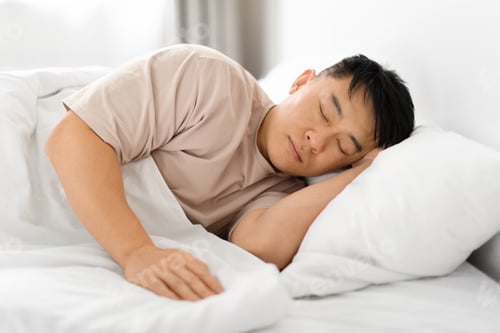 Preview: Tired middle aged asian man asleep, resting peacefully in bed