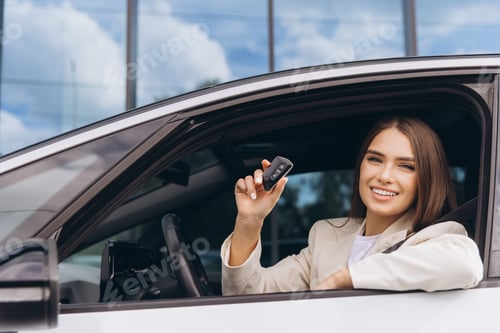 Preview: Smiling Woman Holding Car Keys Sitting Inside Vehicle