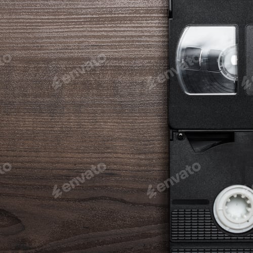 Preview: Old Retro Video Tapes Over Wooden Background