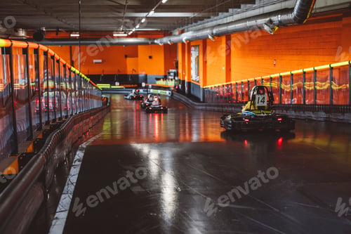 Preview: Go-Kart Racers Navigating a Turn on Indoor Track
