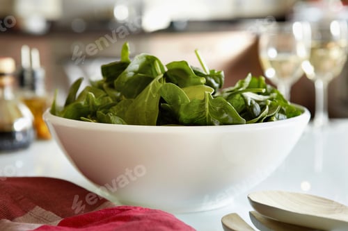 Preview: Bowl of spinach salad on kitchen table