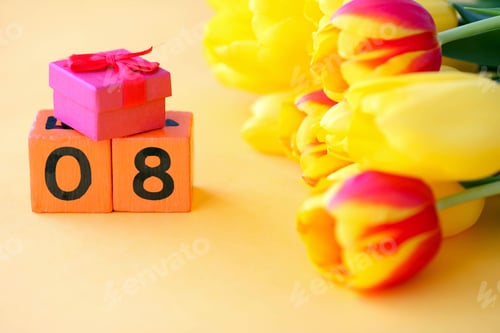 Preview: Wooden calendar with number 8 and a small red box on a background of yellow tulips.