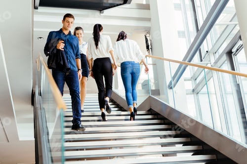 Preview: Group of businessman walking and taking stairs