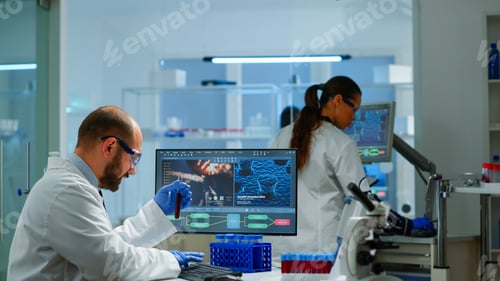 Preview: Laboratory medical stuff disscussing about vaccine development holding test tube
