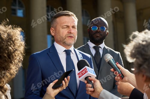 Preview: Middle Aged Caucasian Man Speaking to Reporters during Outdoor Press Conference